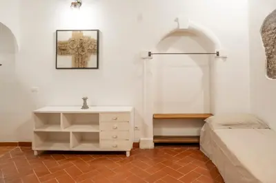 a bedroom with a bed and a white dresser at Home Domus Capocci - Rione Monti in Rome