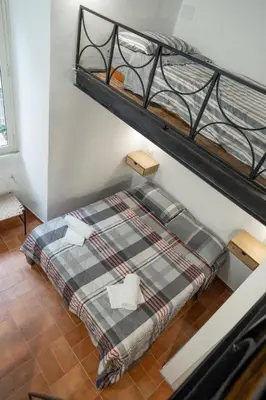 a bedroom with two bunk beds in a room at Home Domus Capocci - Rione Monti in Rome