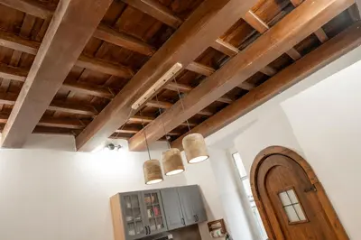 a kitchen with wooden ceilings and wooden beams at Home Domus Capocci - Rione Monti in Rome