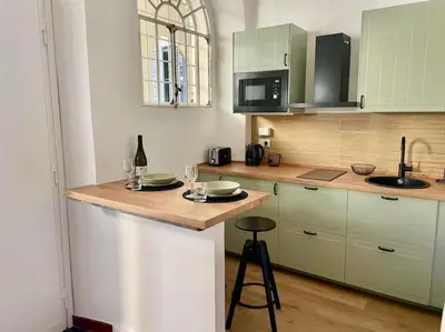 a kitchen with green cabinets and a counter top at Non prenotate in Rome