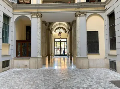 an empty hallway of a building with a large doorway at Non prenotate in Rome