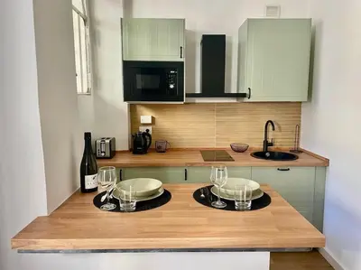 a kitchen with a counter with wine glasses on it at Non prenotate in Rome
