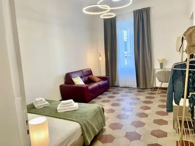 a living room with a bed and a couch at Non prenotate in Rome