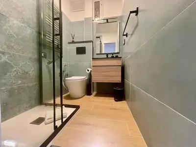 a bathroom with a toilet and a sink and a mirror at Non prenotate in Rome