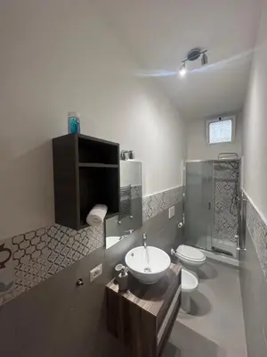 a bathroom with a sink and a toilet and a shower at Sweet RHome in Rome