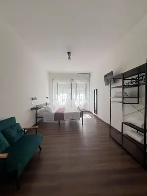 a bedroom with a bed and a couch and bunk beds at Sweet RHome in Rome
