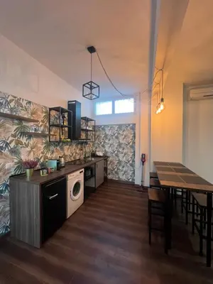 a kitchen and dining room with a table and a microwave at Sweet RHome in Rome