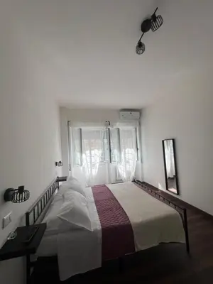 a bedroom with a large bed in front of a window at Sweet RHome in Rome