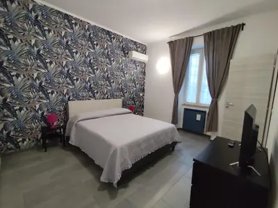 a bedroom with a bed and a wall mural at Casa Gaia - Cozy Urban Oasis in Rome