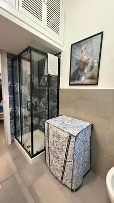a bathroom with a glass shower and a box at Casa Gaia - Cozy Urban Oasis in Rome