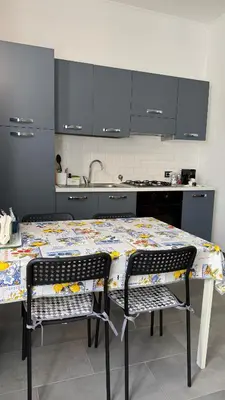 a kitchen with a table and two chairs in front of it at Casa Gaia - Cozy Urban Oasis in Rome