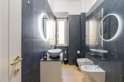 a bathroom with two sinks and two mirrors at Metro A 3 fermate da San Pietro - 2 Camere Luminoso - Domus Valeria in Rome
