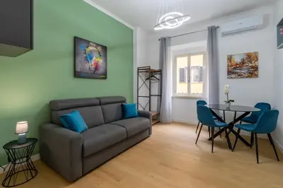 a living room with a couch and a table at Metro A 3 fermate da San Pietro - 2 Camere Luminoso - Domus Valeria in Rome