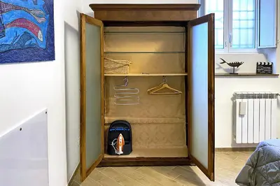 an open refrigerator in a room with a wall at La maisonette romana in Rome