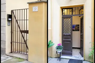 a door of a building with a flower pot next to it at La maisonette romana in Rome