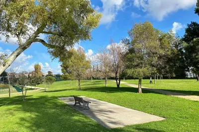 a park with a bench in the grass at La maisonette romana in Rome