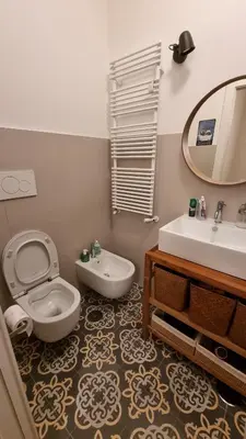 a bathroom with a toilet and a sink and a mirror at Maggie's House in Rome