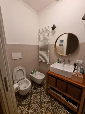 a bathroom with a toilet and a sink and a mirror at Maggie's House in Rome