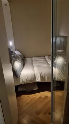 a small bedroom with a bed and a glass door at Maggie's House in Rome