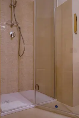 a shower with a glass door on a bathroom at Domus Gianicolensis in Rome