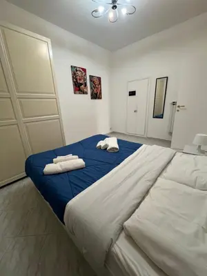 a bedroom with a large bed with towels on it at Casa vacanza La Rosa di Oscar - Testaccio in Rome