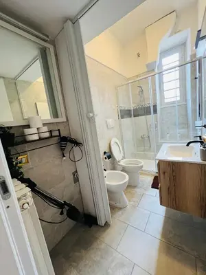 a bathroom with a toilet and a sink and a shower at Casa vacanza La Rosa di Oscar - Testaccio in Rome