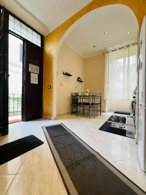 a room with a door and a dining room with a table at Casa vacanza La Rosa di Oscar - Testaccio in Rome