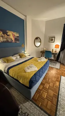 a bedroom with a large bed with a blue wall at Trastevere Welcome Home Superior in Rome