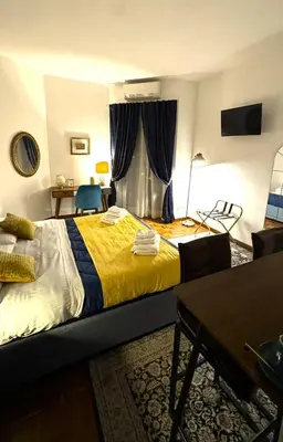 a bedroom with a large bed with a yellow blanket at Trastevere Welcome Home Superior in Rome