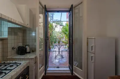 a kitchen with an open door to a patio at Roma centro pochi minuti - Appartamento con giardino privato in Rome