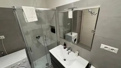a bathroom with a sink and a shower with a mirror at Trastevere Welcome Home Deluxe 2 in Rome