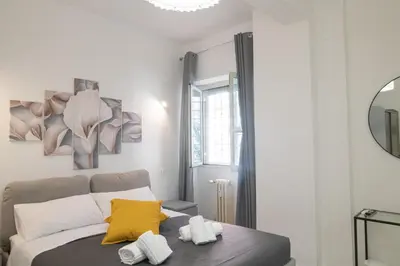 a bedroom with a bed with a yellow pillow on it at Gmm in Rome