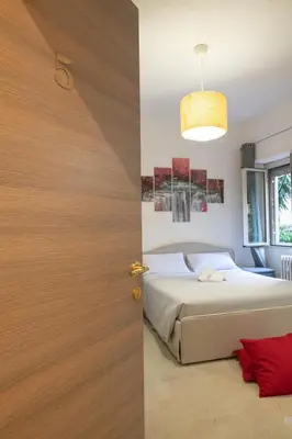 a bedroom with a bed and a wooden door at Gmm in Rome