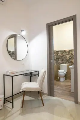 a bathroom with a mirror and a desk and a toilet at Gmm in Rome