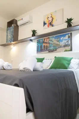 a bedroom with a bed with a painting on the wall at Gmm in Rome