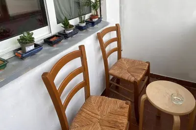 a room with two chairs and a table and a window at Interno33 Appartamento accogliente e moderno vicino Stazione Tiburtina in Rome