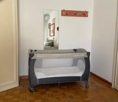 a small bed in a room with a mirror at Interno33 Appartamento accogliente e moderno vicino Stazione Tiburtina in Rome