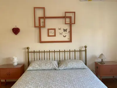 a bedroom with a bed and two night stands and two tables at Interno33 Appartamento accogliente e moderno vicino Stazione Tiburtina in Rome