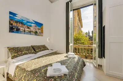 a bedroom with a bed and a large window at Via Veneto - Dolce Vita Alcova in Rome