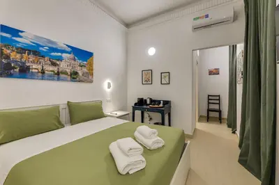 a bedroom with a bed with towels on it at Via Veneto - Dolce Vita Alcova in Rome