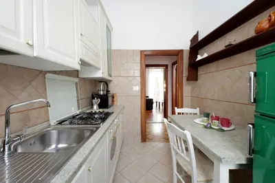 a kitchen with a sink and a stove top oven at 4BNB - Queen Mary Vatican Home in Rome