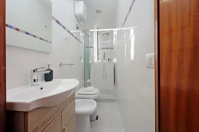 a bathroom with a sink and a toilet and a shower at 4BNB - Queen Mary Vatican Home in Rome