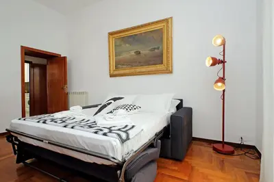 a bed in a room with a picture on the wall at 4BNB - Queen Mary Vatican Home in Rome