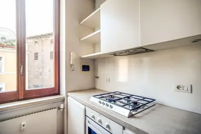 a kitchen with a stove top oven next to a window at Coliseum charming house in Rome