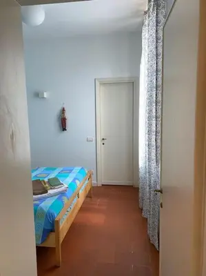 a bedroom with a bed and a hallway with a door at Coliseum charming house in Rome