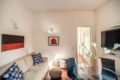 a living room with a couch and a flat screen tv at Coliseum charming house in Rome