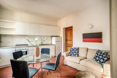 a living room with a couch and a glass table at Coliseum charming house in Rome
