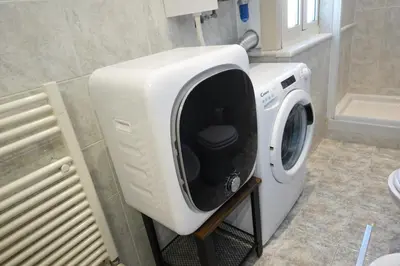 a white washing machine sitting in a bathroom at Close to the Spanish Steps, WIFI, Air Cond, 2 bedrooms in Rome