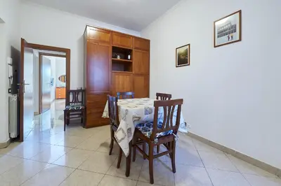 a dining room with a table and chairs and a kitchen at Close to the Spanish Steps, WIFI, Air Cond, 2 bedrooms in Rome