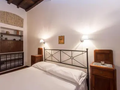 a bedroom with a large bed and a wooden cabinet at Piazza Navona Charming Apartment in Rome